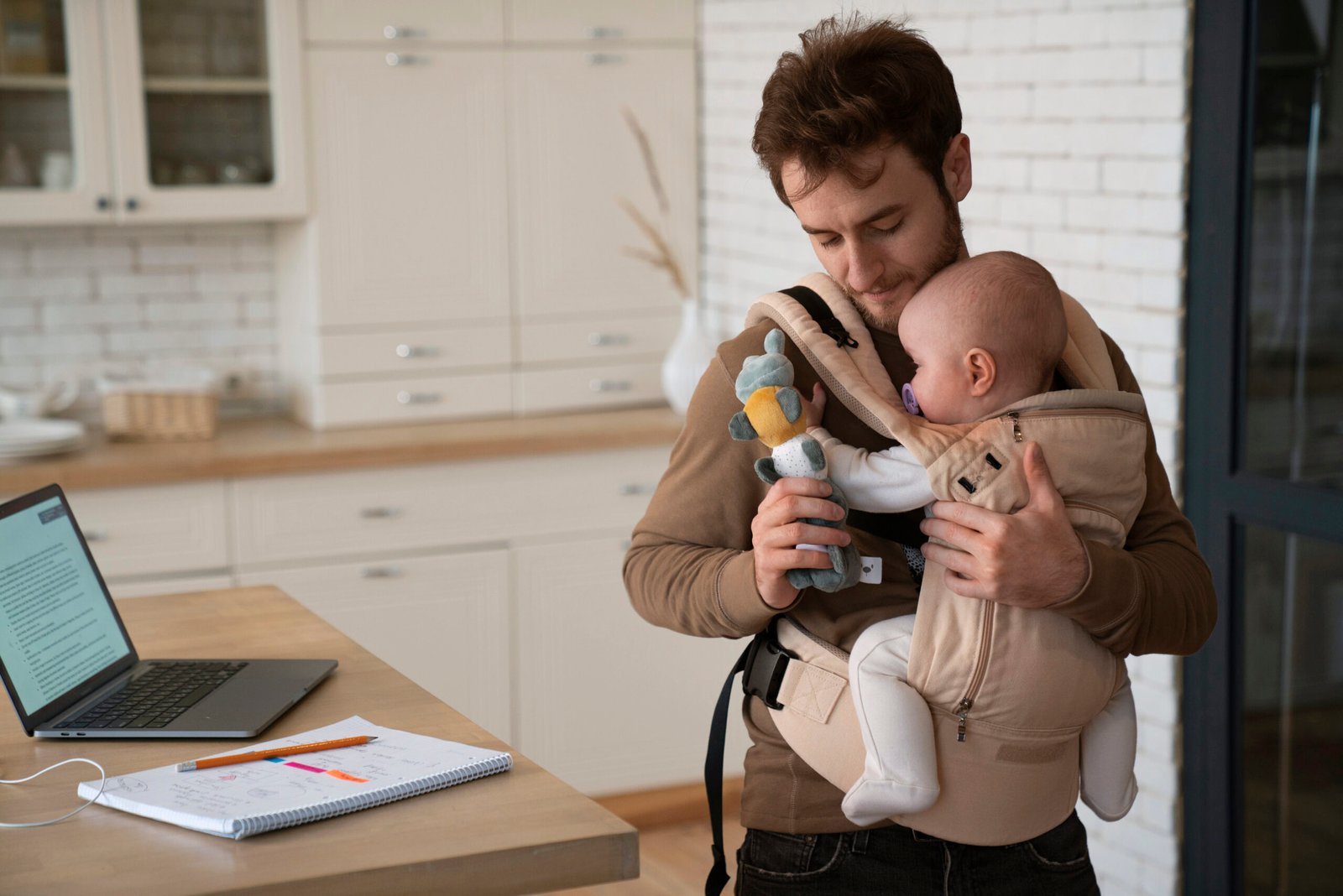 medium-shot-father-working-while-holding-baby